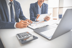 Two businesspeople work at a computer